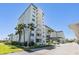 Exterior low angle of condo showing many floors and balconies at 9 Forbes Pl # 205, Dunedin, FL 34698
