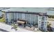Spacious condo building featuring a porte cochere and well-maintained landscaping, offering an inviting entrance at 9 Forbes Pl # 205, Dunedin, FL 34698