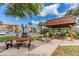 Outdoor gazebo with picnic table and grill provides a relaxing place to gather at 9 Forbes Pl # 205, Dunedin, FL 34698