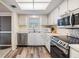 Cozy kitchen with stainless steel appliances, white cabinets, and plenty of counter space at 9 Forbes Pl # 205, Dunedin, FL 34698