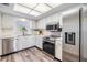 Bright kitchen featuring stainless steel appliances, white cabinets, and modern flooring at 9 Forbes Pl # 205, Dunedin, FL 34698
