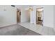 Neutral living room provides tile and carpet flooring with easy access to other rooms at 9 Forbes Pl # 205, Dunedin, FL 34698