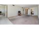Open living room, tile transitions to carpet, has television at 9 Forbes Pl # 205, Dunedin, FL 34698