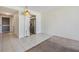 Open floor plan with tile and carpet flooring flows from living room to kitchen and hallway at 9 Forbes Pl # 205, Dunedin, FL 34698