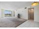 Bright living room features neutral carpet, balcony, and plenty of space for entertaining at 9 Forbes Pl # 205, Dunedin, FL 34698
