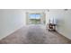 Comfortable living room has a large balcony and neutral carpet for a move-in ready feel at 9 Forbes Pl # 205, Dunedin, FL 34698
