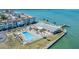 Waterfront complex with pool and clubhouse, offering relaxing views and resort-style amenities by the sea at 9 Forbes Pl # 205, Dunedin, FL 34698