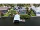 Aerial view of waterfront property featuring solar panels, screened pool, and a private boat dock with lift at 907 Golf Island Dr, Apollo Beach, FL 33572