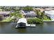 Waterfront home features solar panels, a screened pool, and a private boat dock with lift for boating enthusiasts at 907 Golf Island Dr, Apollo Beach, FL 33572