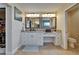 Well lit, dual sink bathroom features a make-up vanity and tile flooring at 907 Golf Island Dr, Apollo Beach, FL 33572