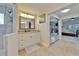 Bright bathroom features a double vanity, granite countertops, neutral tile flooring, and glass enclosed shower at 907 Golf Island Dr, Apollo Beach, FL 33572