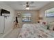 Light and airy bedroom with coastal decor, a telescope, and a ceiling fan with a light at 907 Golf Island Dr, Apollo Beach, FL 33572