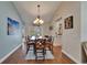 Spacious dining room with hardwood floors, table with seating, and doors to lanai at 907 Golf Island Dr, Apollo Beach, FL 33572