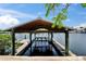 Covered dock with boat lift provides secure moorage and easy access to waterfront adventures at 907 Golf Island Dr, Apollo Beach, FL 33572