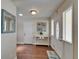 Bright entryway with white door, console table, decor, and hardwood flooring at 907 Golf Island Dr, Apollo Beach, FL 33572