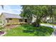 Charming single-story home with a well-manicured lawn and mature landscaping at 907 Golf Island Dr, Apollo Beach, FL 33572
