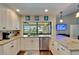 Bright kitchen with stainless steel appliances, granite countertops, and a view of the pool at 907 Golf Island Dr, Apollo Beach, FL 33572