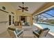 Spacious lanai with seating overlooking a sparkling pool and waterfront view, ideal for outdoor living at 907 Golf Island Dr, Apollo Beach, FL 33572