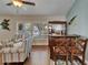 Living room featuring a custom bar area, shuttered windows, hardwood floors, and comfortable seating at 907 Golf Island Dr, Apollo Beach, FL 33572