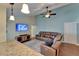 Inviting living room features vaulted ceiling, ceiling fan, and large screen television at 907 Golf Island Dr, Apollo Beach, FL 33572