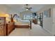 Spacious main bedroom features ceiling fan, slider to pool area, and ensuite bathroom at 907 Golf Island Dr, Apollo Beach, FL 33572