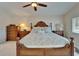 Well-lit main bedroom boasts neutral walls, coordinated furnishings, and ceiling fan at 907 Golf Island Dr, Apollo Beach, FL 33572
