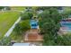 An aerial view of a neighborhood park that includes a playground with swings and a water feature at 907 Golf Island Dr, Apollo Beach, FL 33572