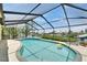 Private screened-in pool surrounded by lush landscaping and clear blue water, perfect for relaxation and recreation at 907 Golf Island Dr, Apollo Beach, FL 33572