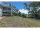 Expansive backyard with screened porch and lush green surroundings, creating a private outdoor oasis at 9520 Indale Dr, New Port Richey, FL 34654