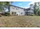 Spacious backyard features mature trees and screened porch at 9520 Indale Dr, New Port Richey, FL 34654