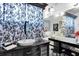 Elegant bathroom featuring a black vanity with a vessel sink, a large mirror, and stylish curtains at 9520 Indale Dr, New Port Richey, FL 34654