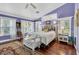 Cozy bedroom with high ceilings, hardwood floors, lots of natural light, and a decorative bench at 9520 Indale Dr, New Port Richey, FL 34654