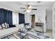 Bright bedroom with a ceiling fan, window bench, and a decorative accent chair at 9520 Indale Dr, New Port Richey, FL 34654
