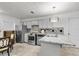 Bright kitchen with stainless steel appliances, a breakfast bar, and a view of the living area at 9520 Indale Dr, New Port Richey, FL 34654