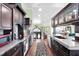 Gourmet kitchen with stainless steel appliances, granite countertops, and rich wood cabinets and hardwood floors at 9520 Indale Dr, New Port Richey, FL 34654