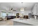 Open-concept kitchen and living space with modern lighting and neutral decor at 9520 Indale Dr, New Port Richey, FL 34654