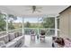 Relaxing screened patio featuring comfortable wicker furniture and serene outdoor views at 9520 Indale Dr, New Port Richey, FL 34654