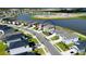 Aerial view of a residential area, showcasing home locations, street layout and proximity to a pond at 9567 Sandy Bluffs Cir, Parrish, FL 34219