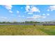 Lush backyard with a serene lake view, providing a tranquil setting and opportunity for relaxation and recreation at 9567 Sandy Bluffs Cir, Parrish, FL 34219