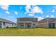 Spacious backyard with a covered patio perfect for entertaining and enjoying the outdoor living at 9567 Sandy Bluffs Cir, Parrish, FL 34219