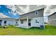 Well-maintained backyard with green lawn, a covered patio, and plenty of space for outdoor enjoyment at 9567 Sandy Bluffs Cir, Parrish, FL 34219