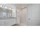Bathroom featuring granite double vanity, walk-in shower, and tile flooring at 9567 Sandy Bluffs Cir, Parrish, FL 34219