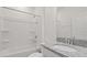 Clean bathroom featuring a shower-tub combo and granite countertop sink at 9567 Sandy Bluffs Cir, Parrish, FL 34219