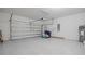 Spacious garage with epoxy floors, an automatic door, and ample storage for vehicles and equipment at 9567 Sandy Bluffs Cir, Parrish, FL 34219