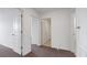 Neutral-toned hallway with doors and carpet flooring at 9567 Sandy Bluffs Cir, Parrish, FL 34219