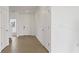 Neutral hallway featuring tile floors, white walls and doors, with a staircase visible in the background at 9567 Sandy Bluffs Cir, Parrish, FL 34219