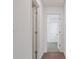 Bright hallway featuring neutral walls, carpet flooring, and white trim doors at 9567 Sandy Bluffs Cir, Parrish, FL 34219