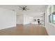 Open-concept living room with tile flooring and view of the modern kitchen at 9567 Sandy Bluffs Cir, Parrish, FL 34219