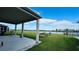 Relaxing covered patio with a view of the lake, providing an ideal space for outdoor living and dining at 9567 Sandy Bluffs Cir, Parrish, FL 34219