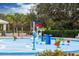 Outdoor splash pad area with colorful water features and tropical landscaping for community fun at 9567 Sandy Bluffs Cir, Parrish, FL 34219